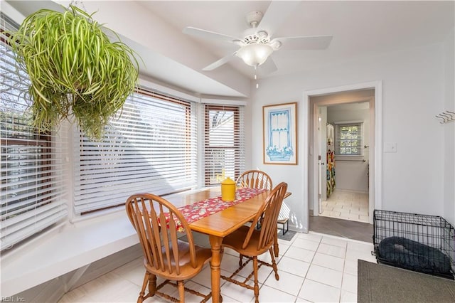 dining space with light tile patterned flooring, plenty of natural light, and ceiling fan