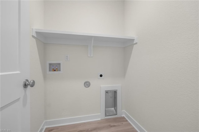 laundry area featuring hardwood / wood-style flooring, washer hookup, hookup for a gas dryer, and electric dryer hookup