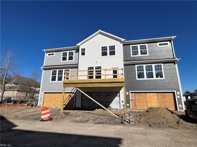 rear view of house with a garage