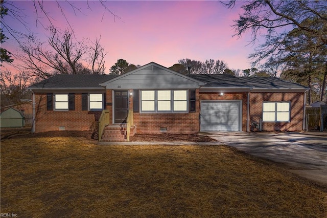 single story home with a garage and a lawn