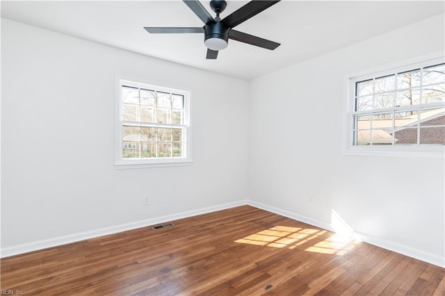 unfurnished room with hardwood / wood-style floors and ceiling fan