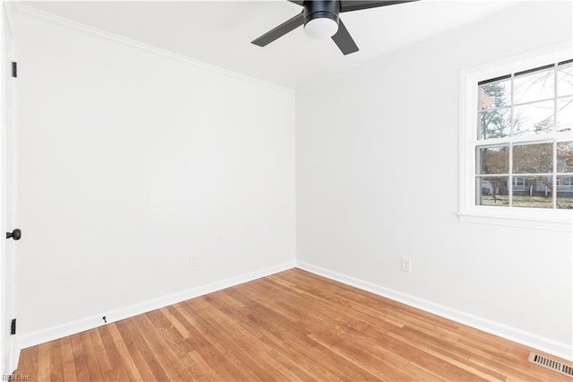 spare room with wood-type flooring, crown molding, and ceiling fan