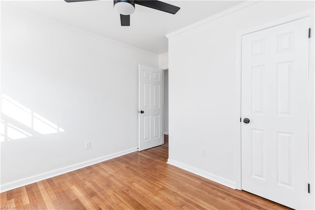 unfurnished bedroom with hardwood / wood-style floors, ornamental molding, and ceiling fan