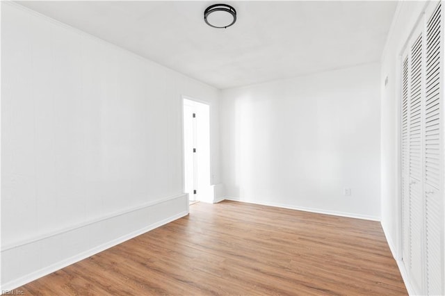 unfurnished bedroom with wood-type flooring and a closet