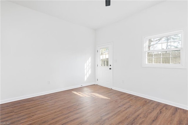 empty room with dark wood-type flooring