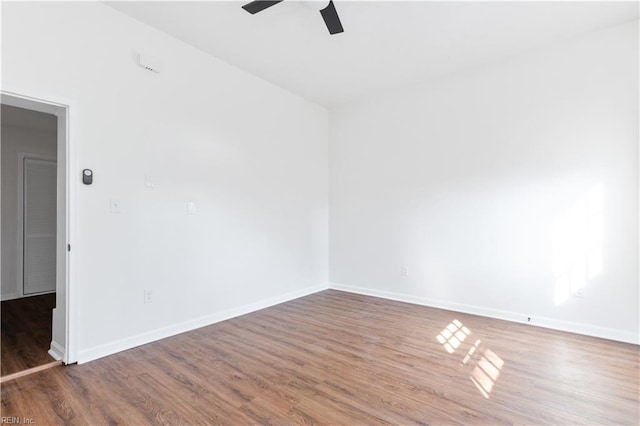 unfurnished room with ceiling fan and wood-type flooring