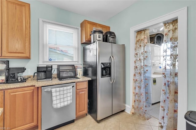 kitchen with stainless steel appliances and light tile patterned flooring