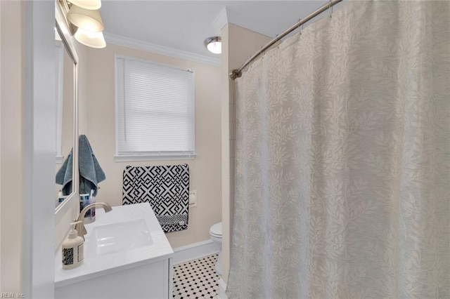 bathroom featuring vanity, tile patterned floors, crown molding, and toilet