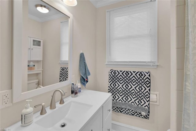 bathroom featuring crown molding, vanity, and toilet