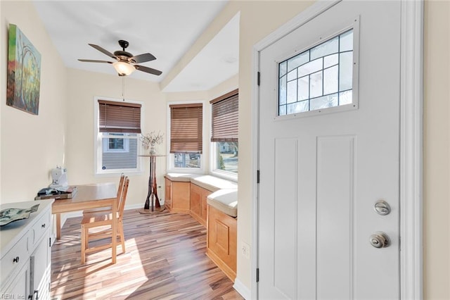 kitchen with white cabinets, ceiling fan, and light hardwood / wood-style flooring