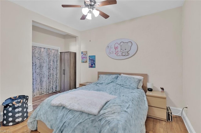 bedroom featuring hardwood / wood-style floors and ceiling fan