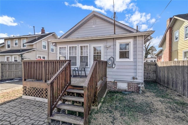 back of property featuring a deck and a patio area