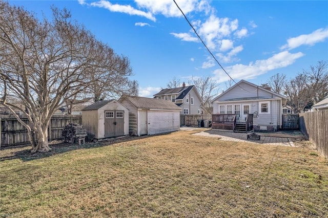 view of yard featuring a storage shed and a wooden deck