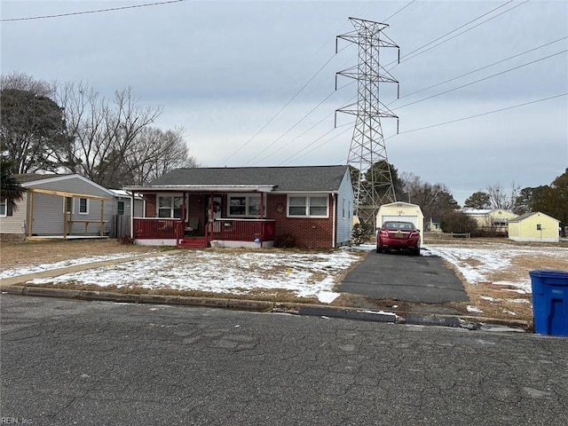 view of front of property with a garage, an outbuilding, and covered porch