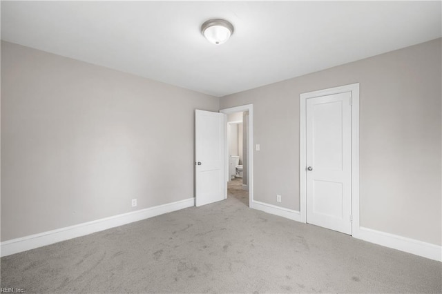 unfurnished bedroom with carpet floors and a closet