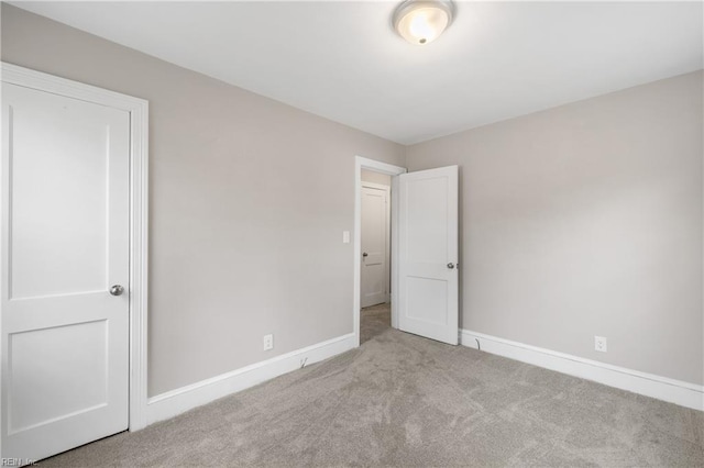 unfurnished bedroom featuring light carpet