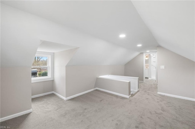 bonus room featuring lofted ceiling and light carpet