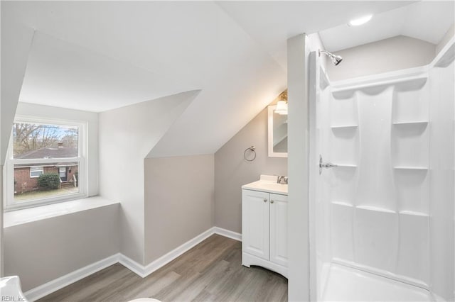 bathroom featuring lofted ceiling, wood-type flooring, and vanity