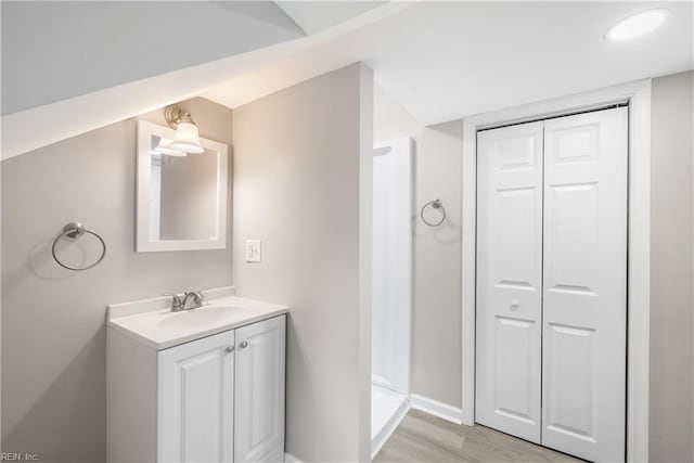 bathroom with hardwood / wood-style flooring and vanity