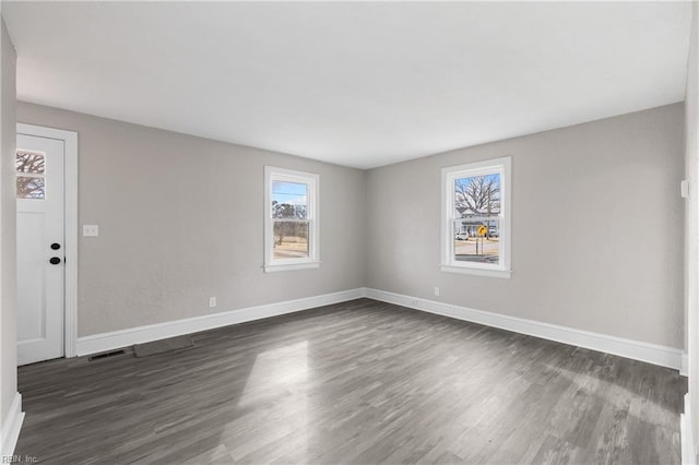 spare room with dark wood-type flooring