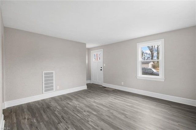 empty room featuring dark hardwood / wood-style flooring