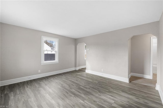 spare room featuring dark wood-type flooring