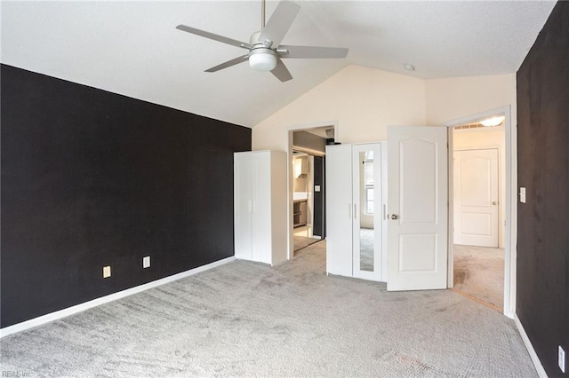 unfurnished bedroom with light carpet, vaulted ceiling, and ceiling fan