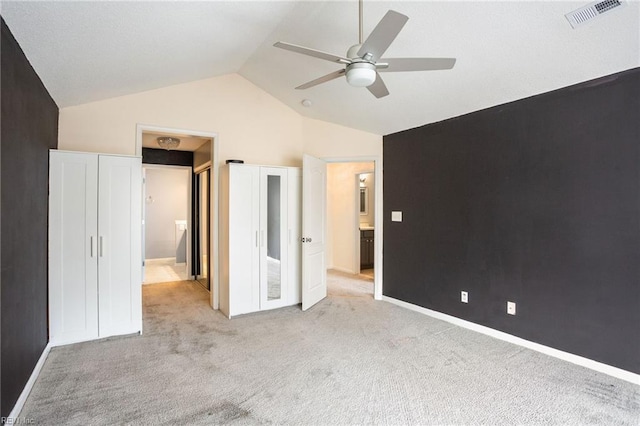 unfurnished bedroom with lofted ceiling, light carpet, and ceiling fan