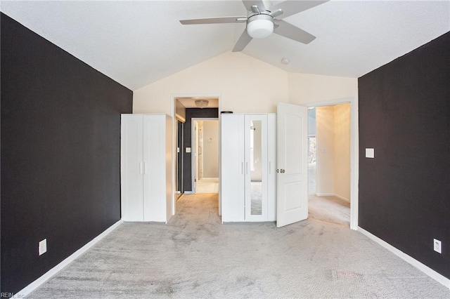 unfurnished bedroom with ceiling fan, light colored carpet, and lofted ceiling