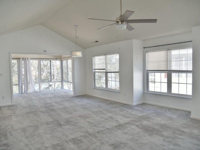 unfurnished living room with vaulted ceiling, light colored carpet, and ceiling fan