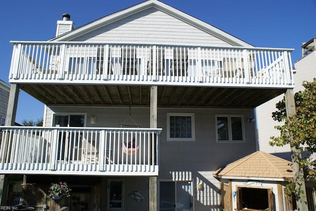 back of property with a balcony