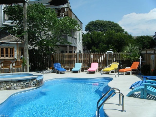 view of swimming pool with a patio and an in ground hot tub