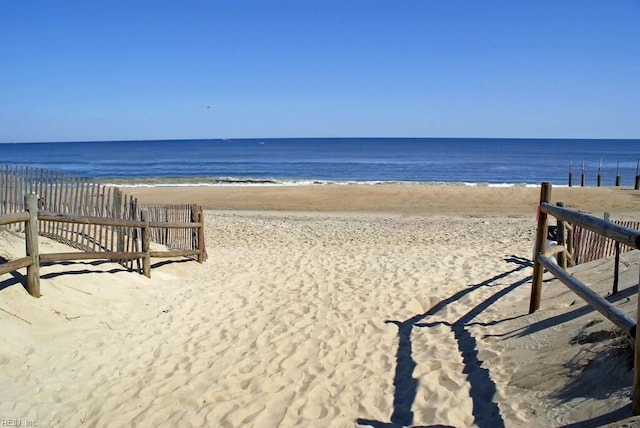 view of home's community with a water view and a view of the beach