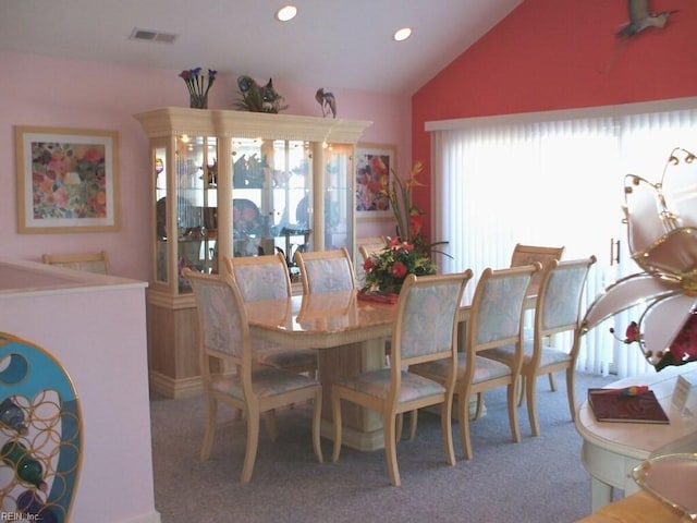 dining space featuring lofted ceiling and carpet floors