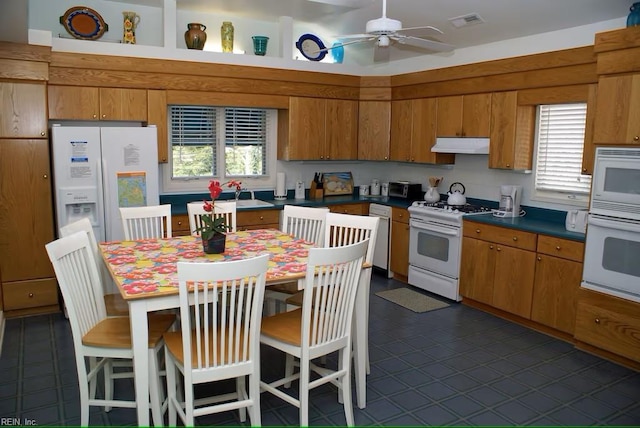 kitchen featuring ceiling fan, sink, and white appliances