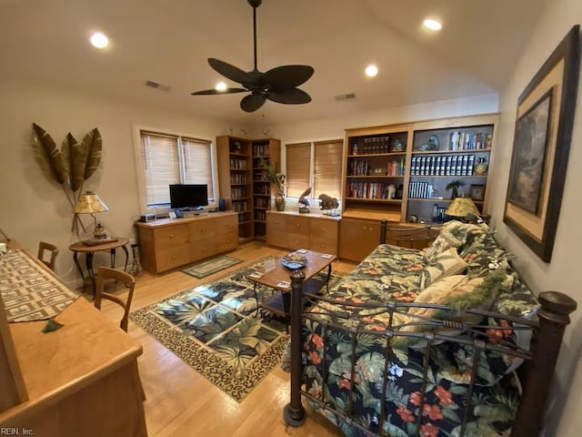 living room with light hardwood / wood-style floors and ceiling fan