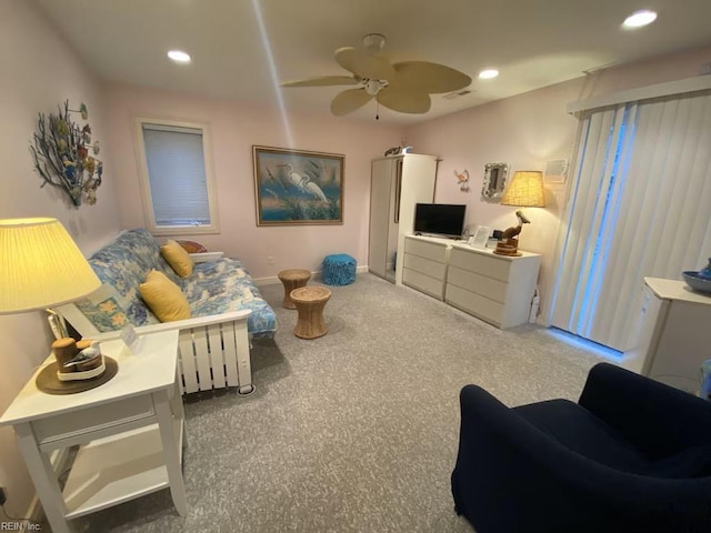 living room with ceiling fan and carpet