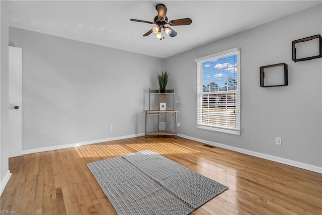 empty room with ceiling fan and wood-type flooring