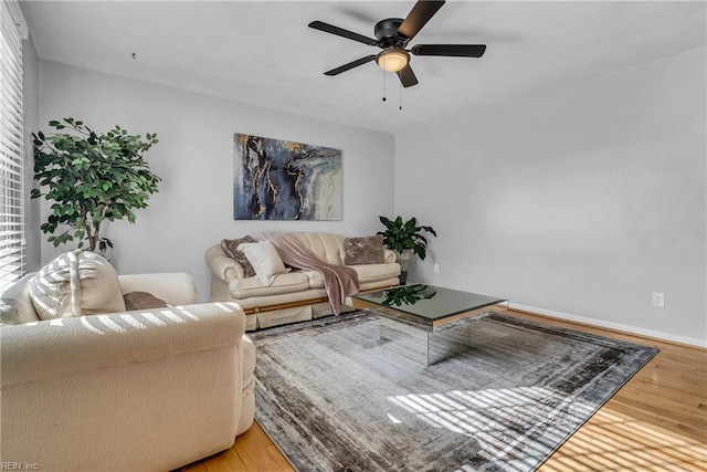 living room featuring hardwood / wood-style floors and ceiling fan