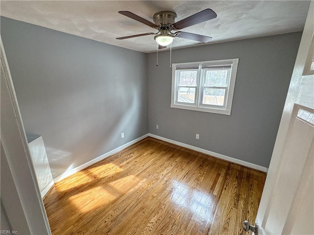 empty room featuring ceiling fan and light wood-type flooring