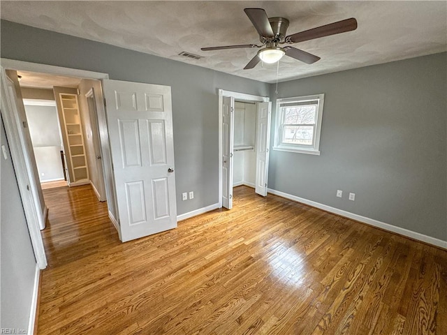 unfurnished bedroom with ceiling fan, a closet, and light hardwood / wood-style flooring