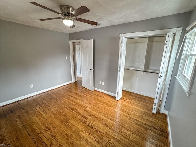 unfurnished bedroom with ceiling fan, light hardwood / wood-style floors, and a closet