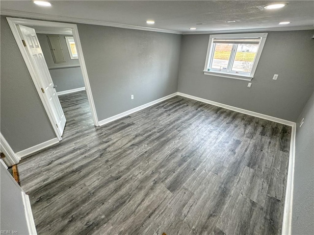 empty room featuring crown molding and dark hardwood / wood-style floors