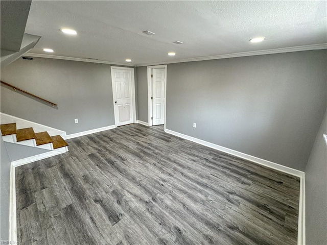 interior space featuring crown molding, dark hardwood / wood-style floors, and a textured ceiling