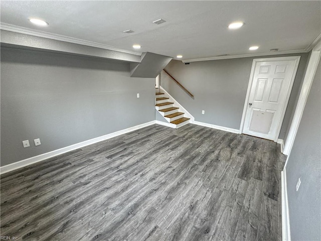 basement featuring dark hardwood / wood-style flooring and ornamental molding