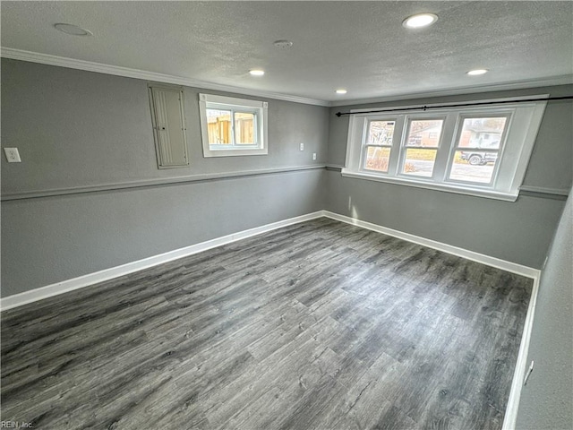 basement with ornamental molding, wood-type flooring, and a textured ceiling