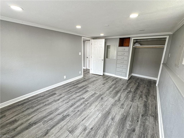 unfurnished bedroom featuring crown molding, dark wood-type flooring, and a textured ceiling