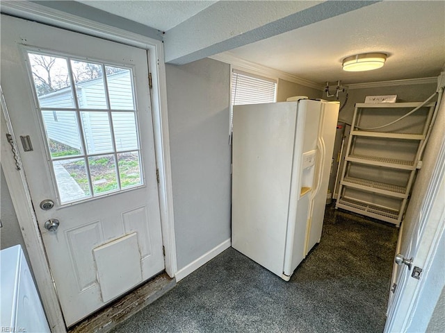 kitchen featuring ornamental molding, a textured ceiling, and white fridge with ice dispenser