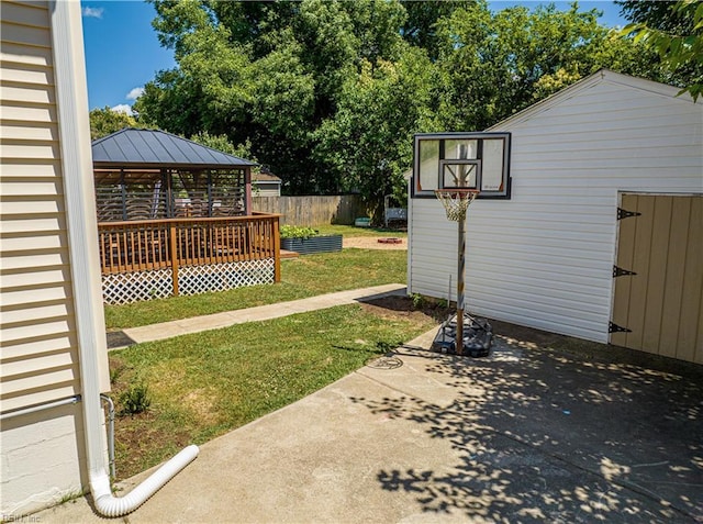 view of yard featuring a gazebo, a deck, and an outbuilding