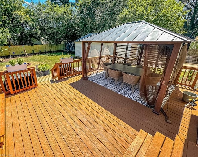 wooden deck with a gazebo and a yard